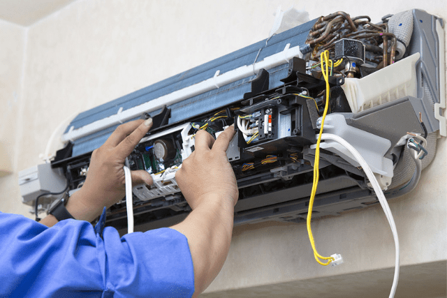 Split AC being mounted indoors